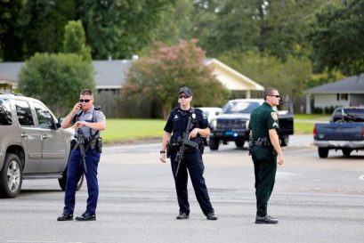 Police officers block off a road after a shooting of police in Baton Rouge